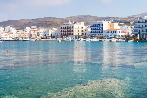 Transparent water, blue sky and white houses in Tinos, the Cyclades.